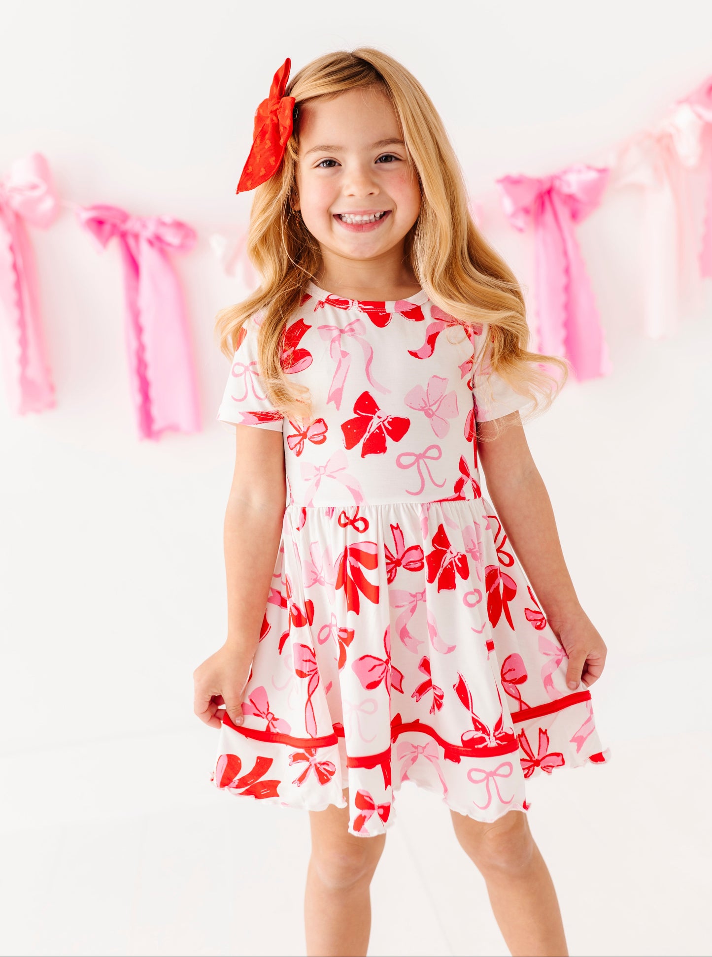 Girls bamboo dress with red and pink bow print and flutter sleeves