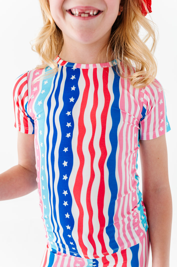 Child wearing a 4th of July bamboo pajama set on a white background