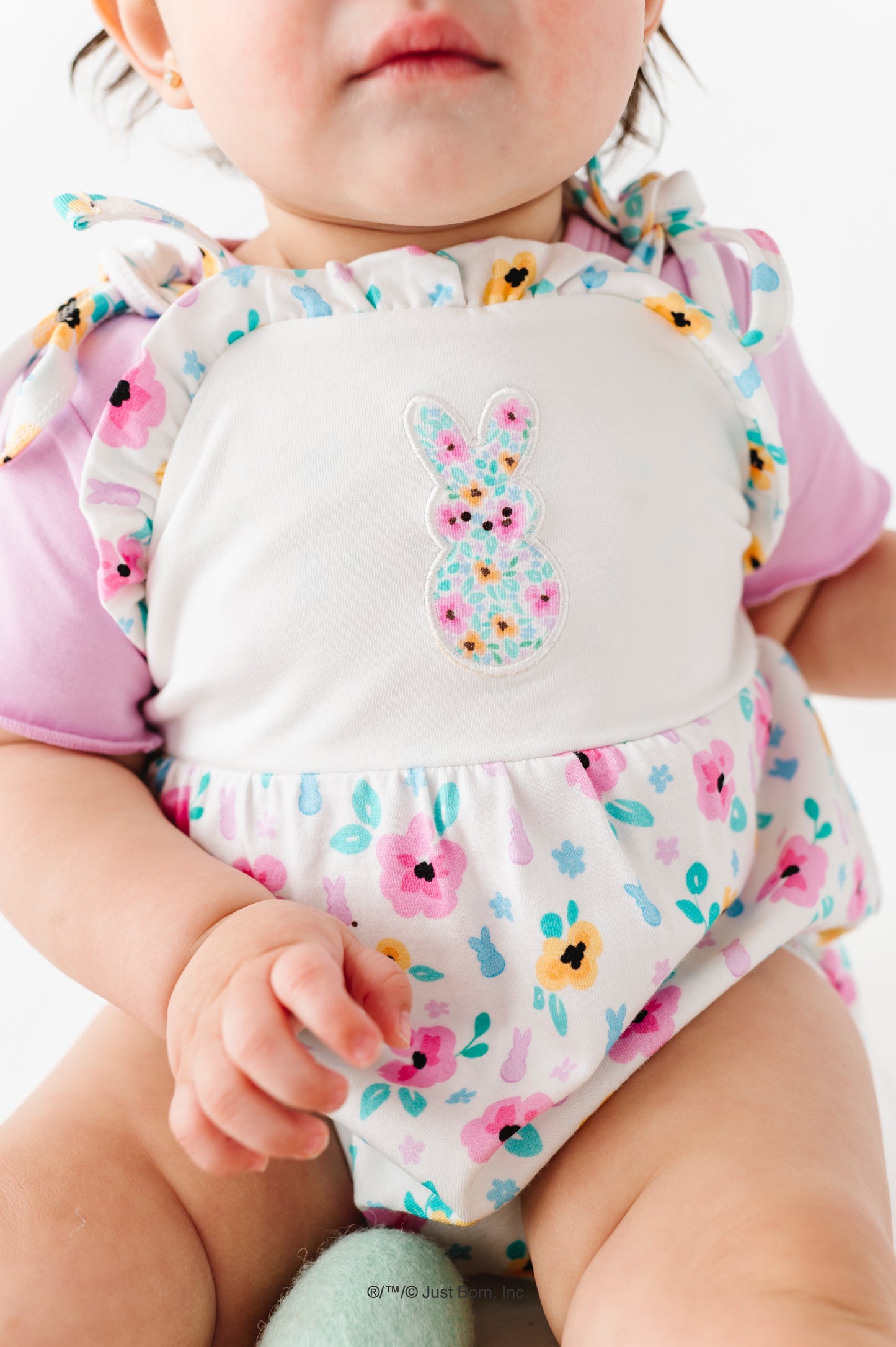 Baby wearing a colorful PEEPS® Easter outfit with a lavender bamboo tee underneath