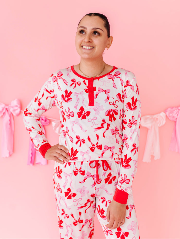 Woman wearing Blushing Bows bamboo pajama set with red and pink bow print