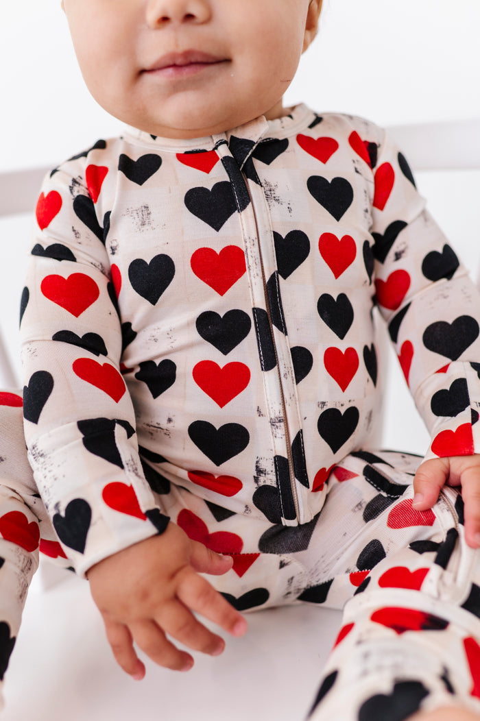 Close-up of King of Hearts bamboo romper showing 2-way zipper and heart pattern