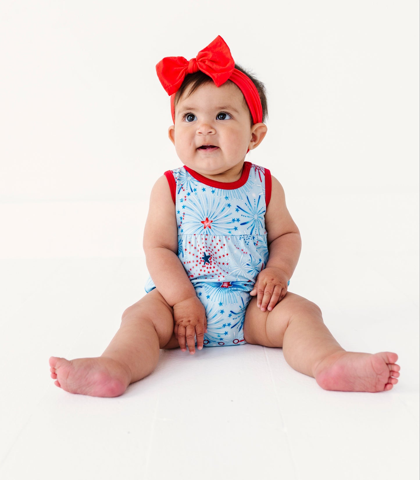 Baby wearing a patriotic bamboo bubble romper on a white background