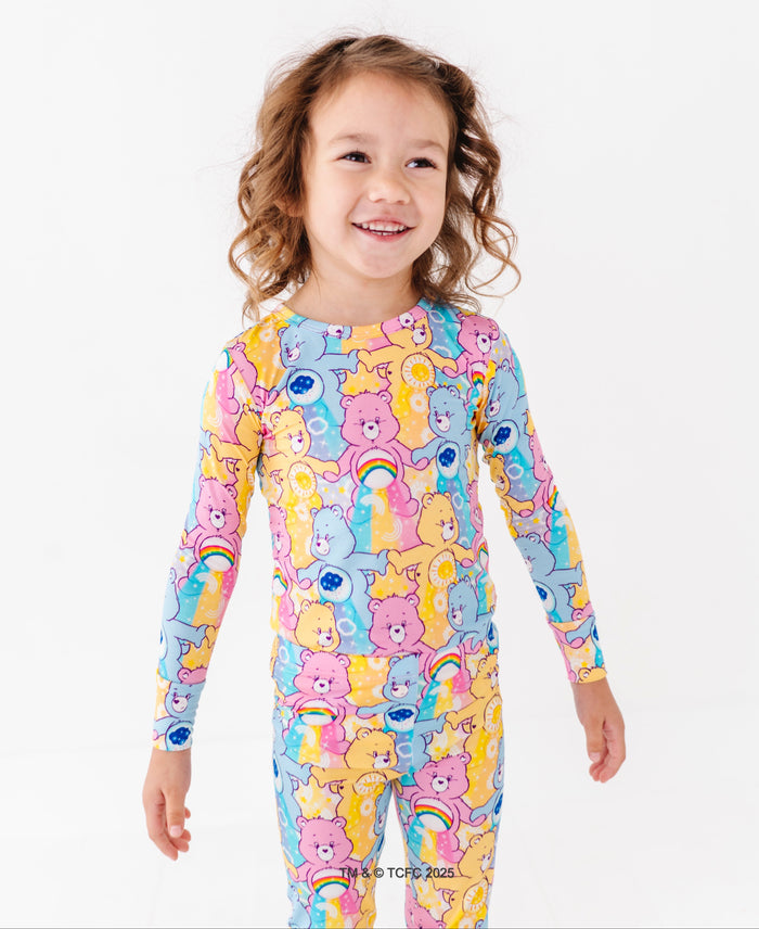 Care Bears™ bamboo pajamas for toddlers with rainbow, sun, and cloud character details