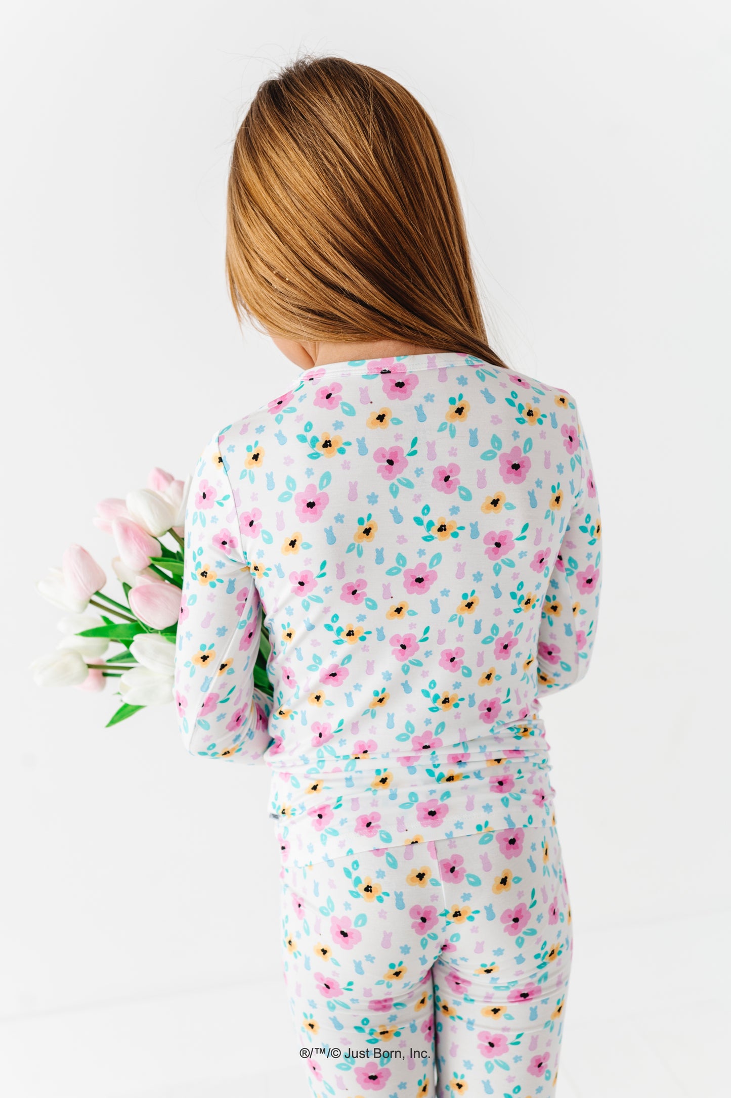 Child wearing a floral PEEPS® bamboo pajama set with a white background