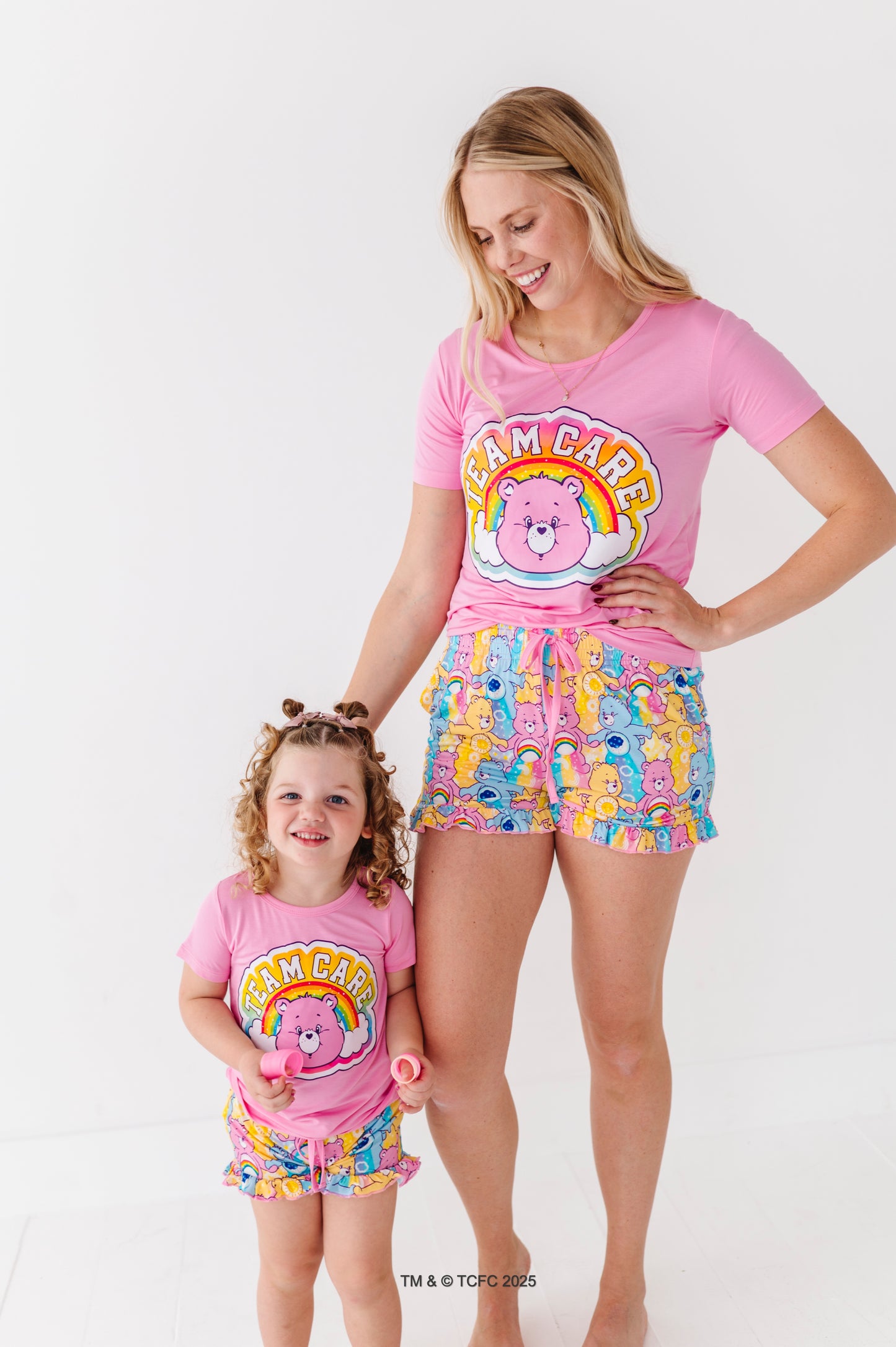 Matching mom and toddler wearing Care Bears bamboo lounge sets on white background