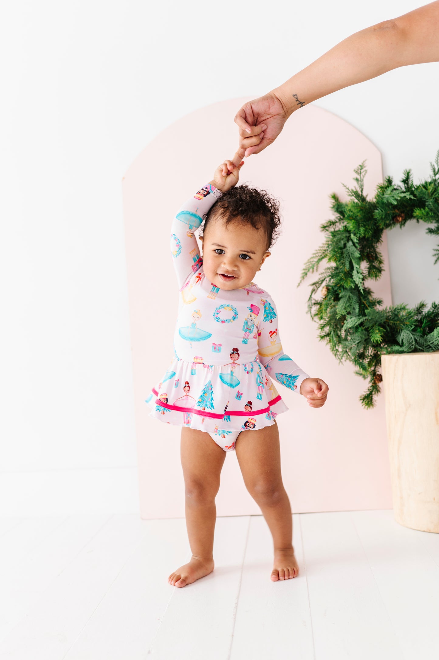 Baby in a holiday dress made from bamboo viscose with tiered twirl skirt
