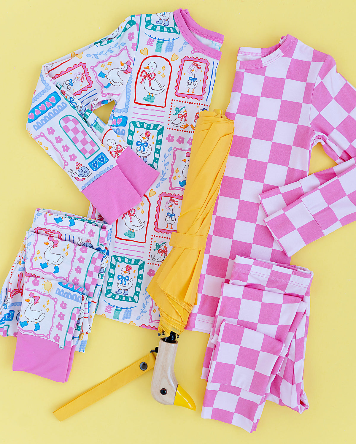 Children's pajama set with goose and checkered bamboo designs on a yellow background
