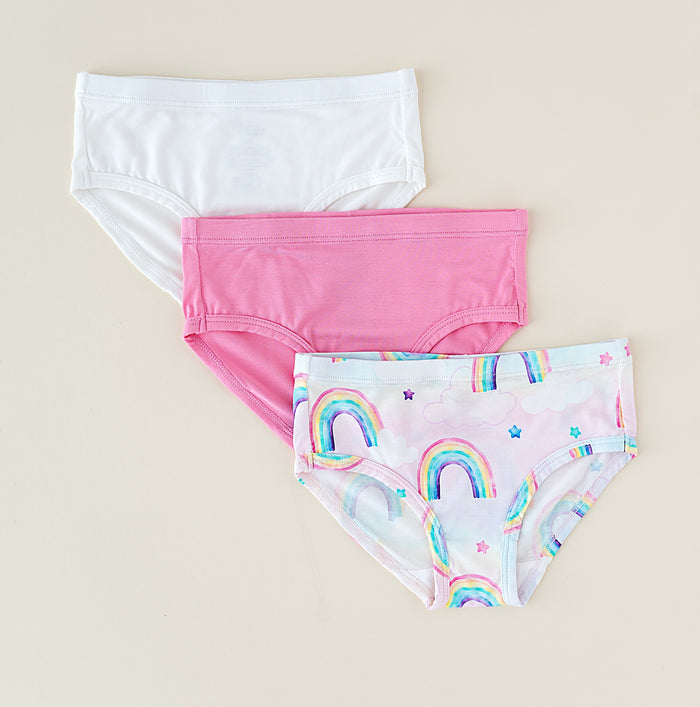 Three pairs of bamboo underwear with different designs on a beige background