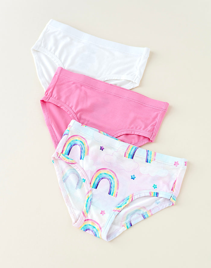 Three pairs of bamboo underwear with different designs on a beige background