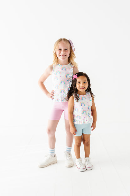 Two young girls wearing matching bamboo cotton outfits with a white background