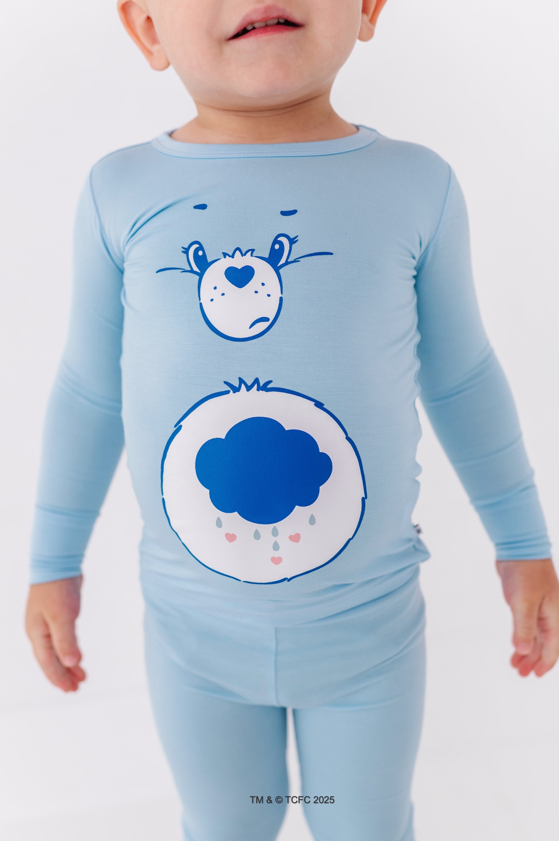 Close-up of Grumpy Bear pajama top showing cloud belly badge detail