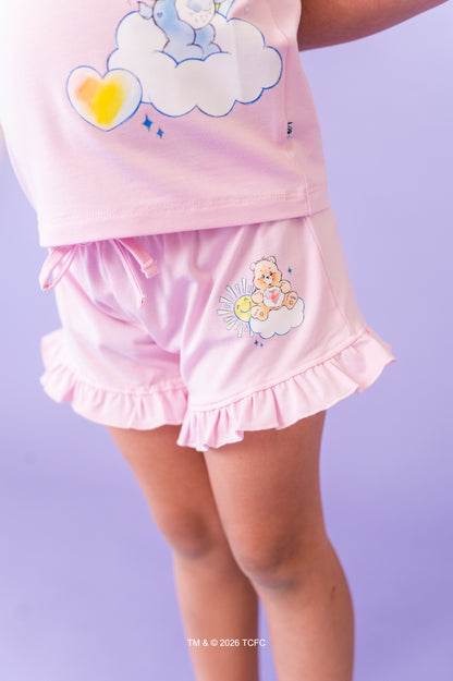 Children's lilac short set with cloud and Care Bears™ design on a purple background