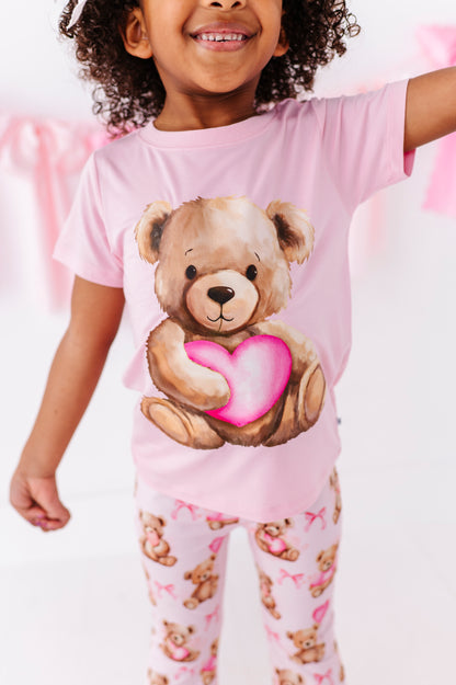 Close-up of pink bamboo t-shirt with watercolor teddy bear heart graphic