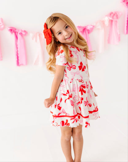 Girls bamboo dress with red and pink bow print and flutter sleeves