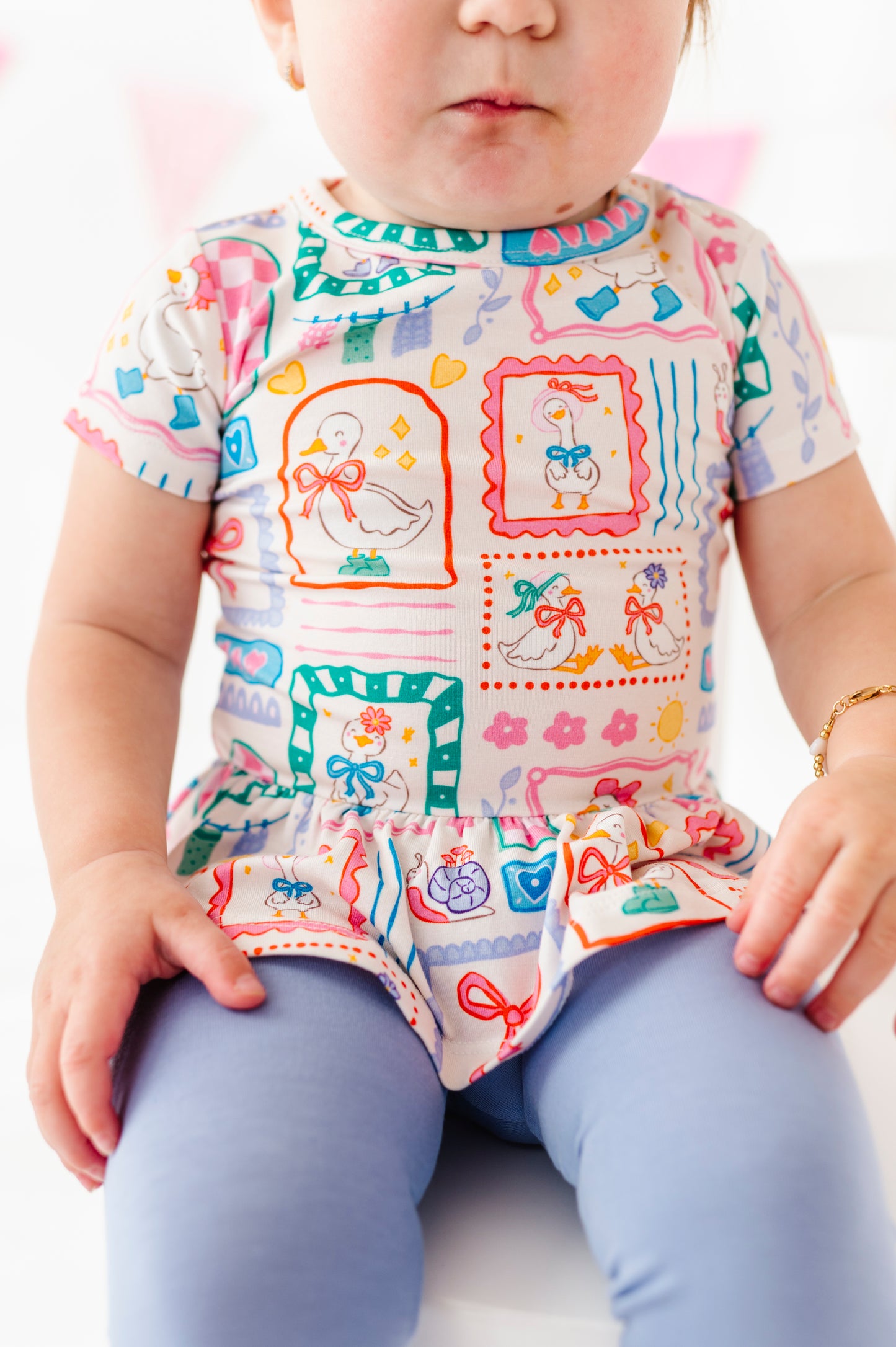 Child wearing a colorful bamboo shirt with a plain background