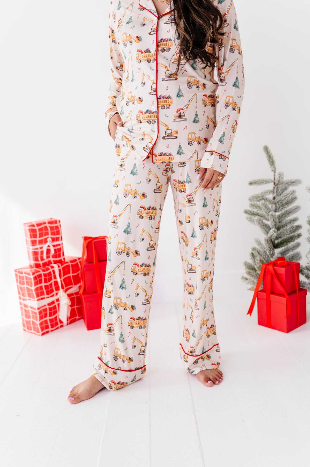 A mom wearing bamboo Christmas construction-themed two-piece pajamas 