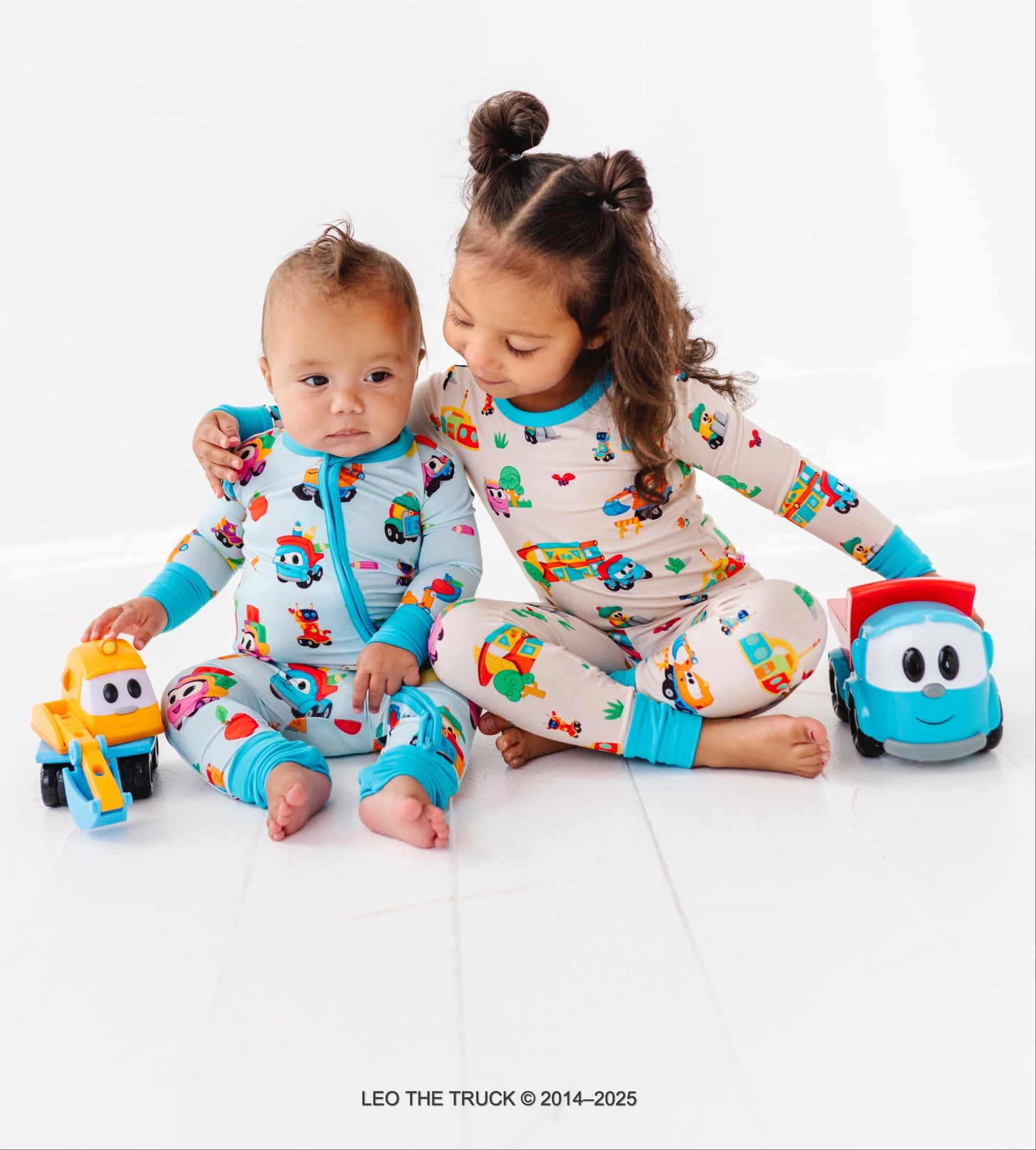 Two children in colorful Leo the Truck bamboo pajamas 
