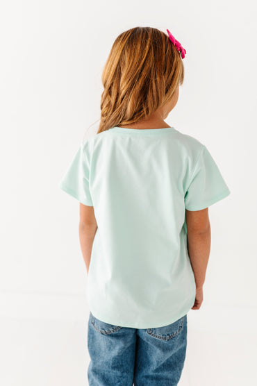 Back view of mint green children’s t-shirt showing smooth lightweight fabric and relaxed fit