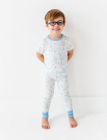 Child wearing a light blue bamboo pajama set with a white background