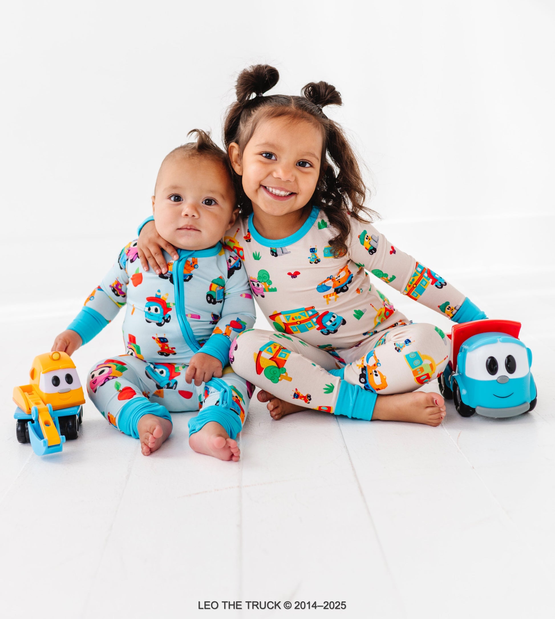 Siblings wearing coordinating Leo the Truck bamboo pajamas