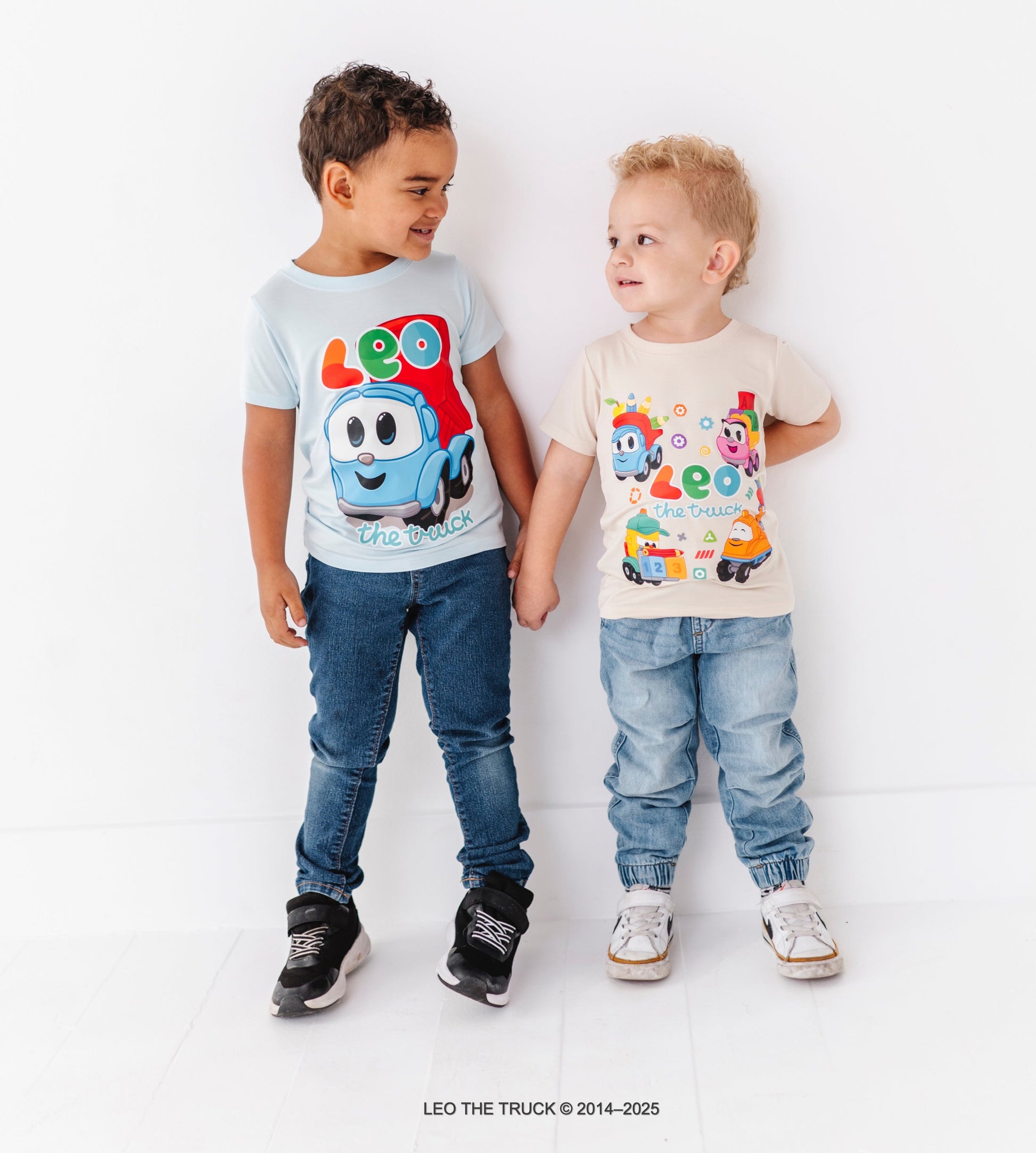 Two children wearing bamboo t-shirts with Leo the Truck on a white background