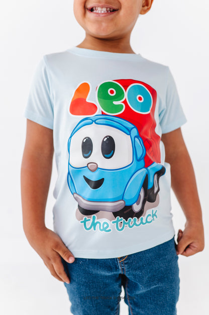 Close-up of a child's bamboo t-shirt with a cartoon character named 'Leo the Truck' on a white background