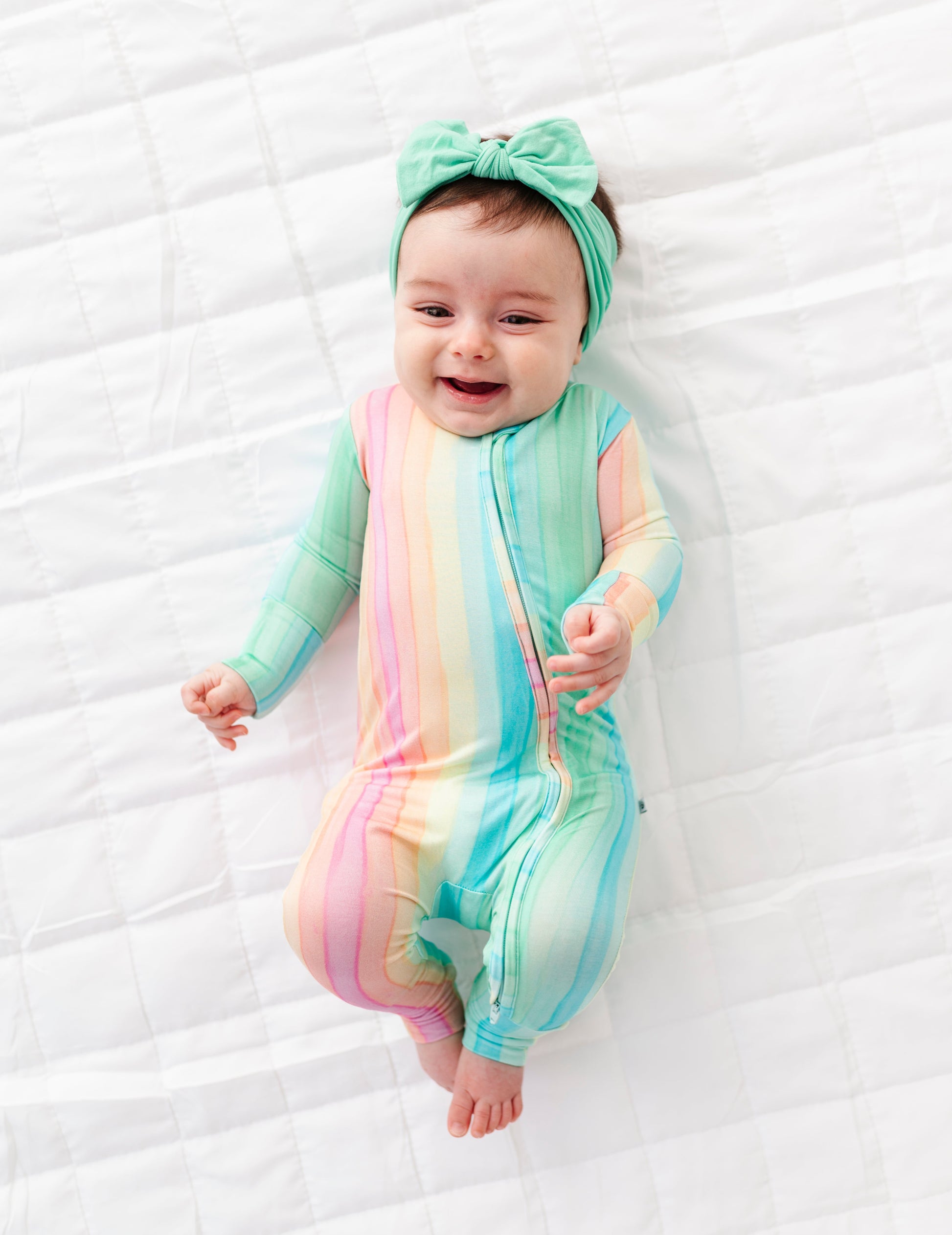 Rainbow stripe bamboo baby romper featuring convertible foot cuffs and breathable stretchy material