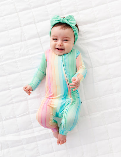 Rainbow stripe bamboo baby romper featuring convertible foot cuffs and breathable stretchy material