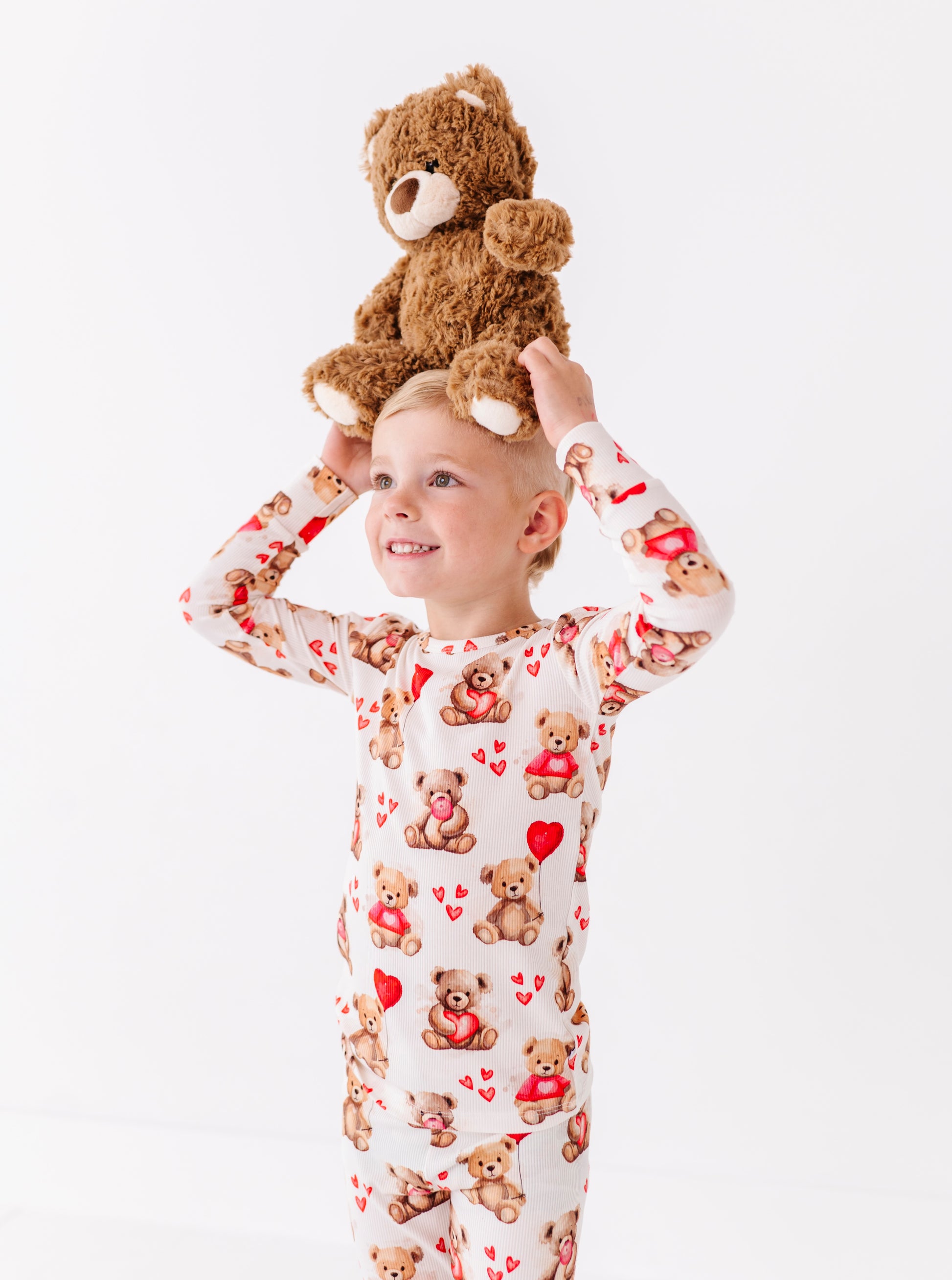 Child wearing Beary Sweet ribbed bamboo pajamas with teddy bear and heart print