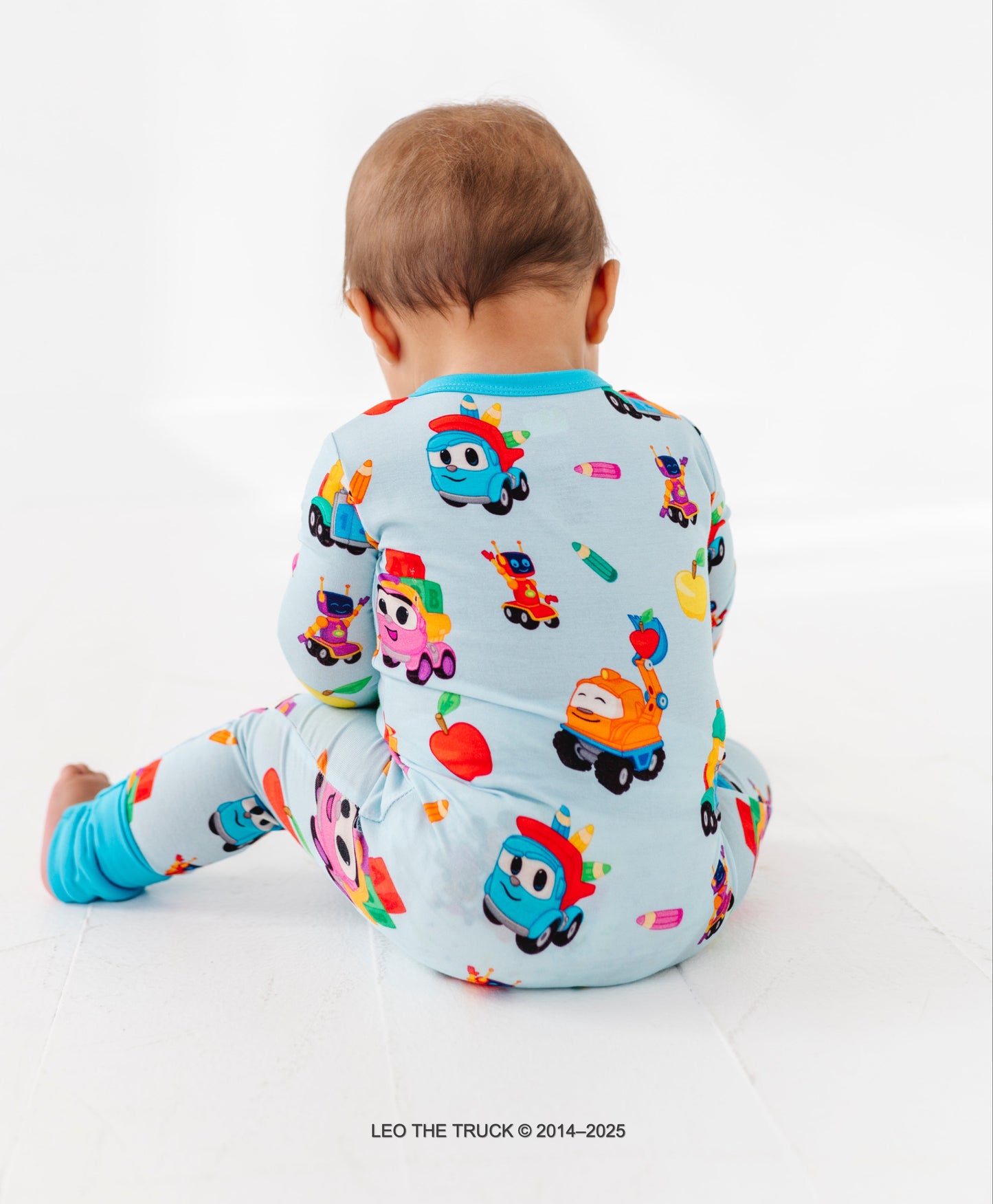 Baby boy wearing a light blue Leo the Truck and crew bamboo convertible romper on a white background