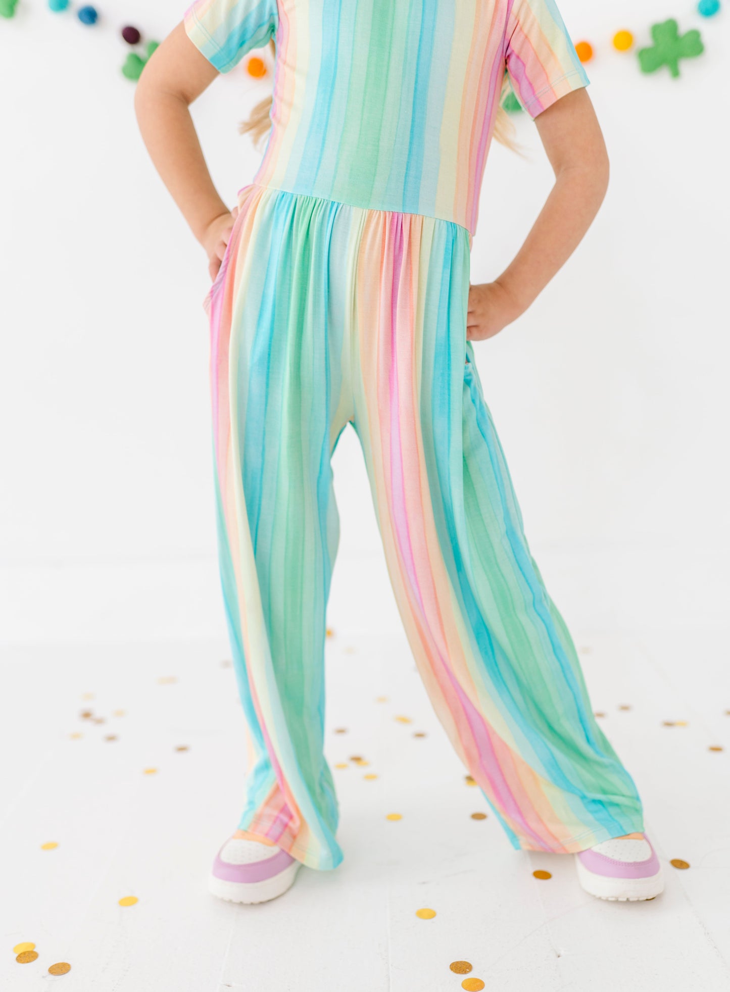 Close-up of rainbow stripe bamboo jumpsuit fabric with pastel vertical stripes