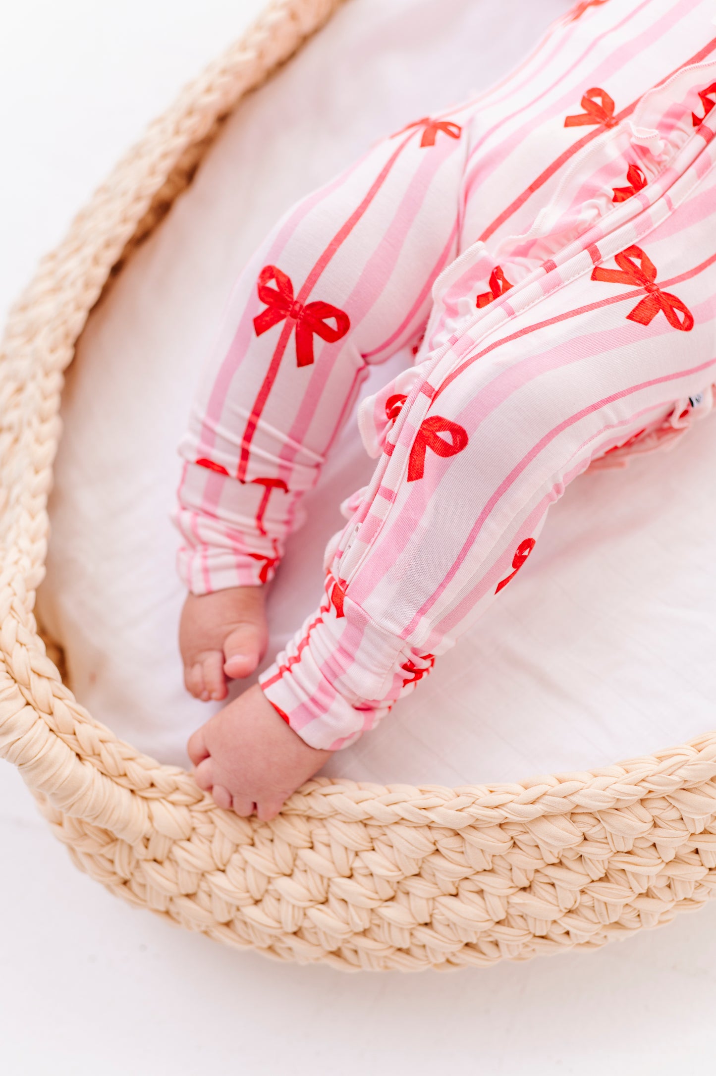 Detail shot of Ruby Ribbons romper zipper and ruffle trim on bamboo fabric