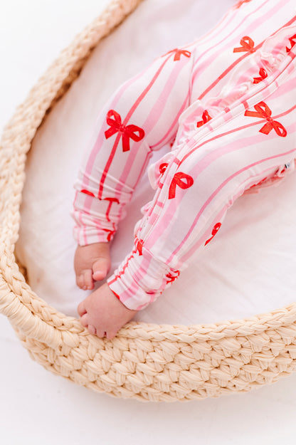 Detail shot of Ruby Ribbons romper zipper and ruffle trim on bamboo fabric