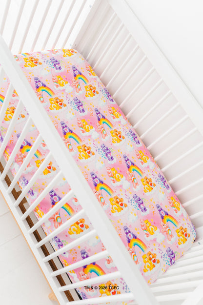 Colorful Care Bears™ bamboo crib sheet  on a white crib.