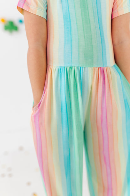 Detail view of rainbow stripe jumpsuit showing soft bamboo viscose texture