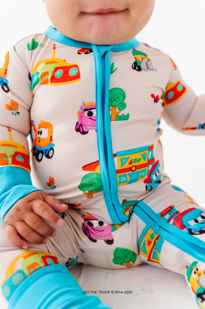 Close-up shot of Leo the Truck bamboo print, highlighting the two-way zip romper and foldover cuffs 