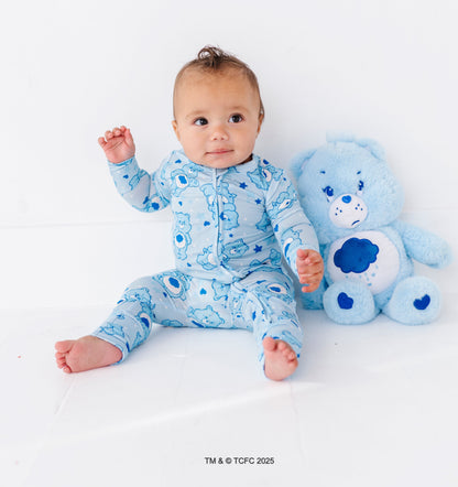 Infant sitting in Grumpy Bear sleeper with tagless neckline and gentle stretch