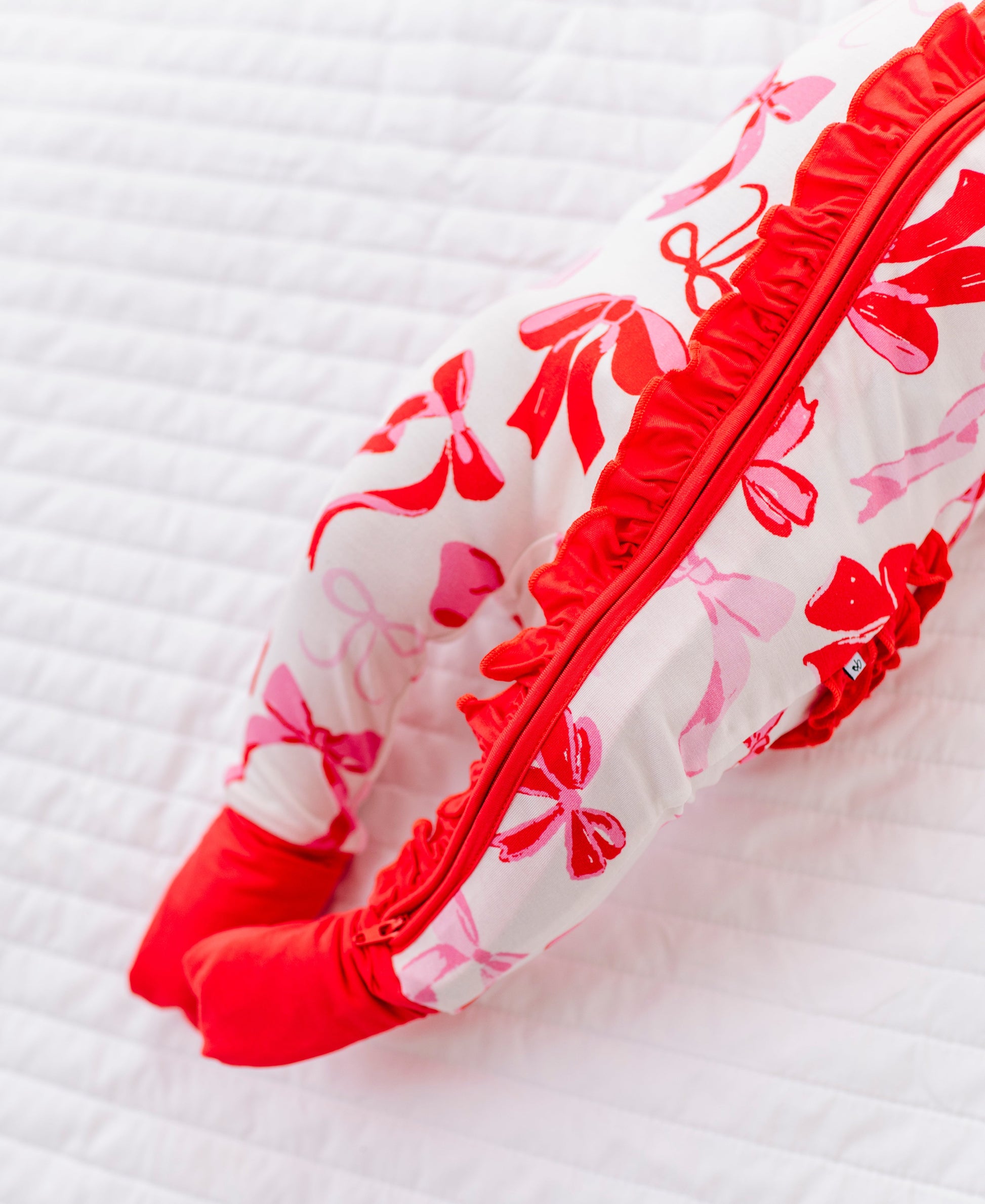 Detail shot of ruffle trim and zipper on Blushing Bows bamboo baby romper