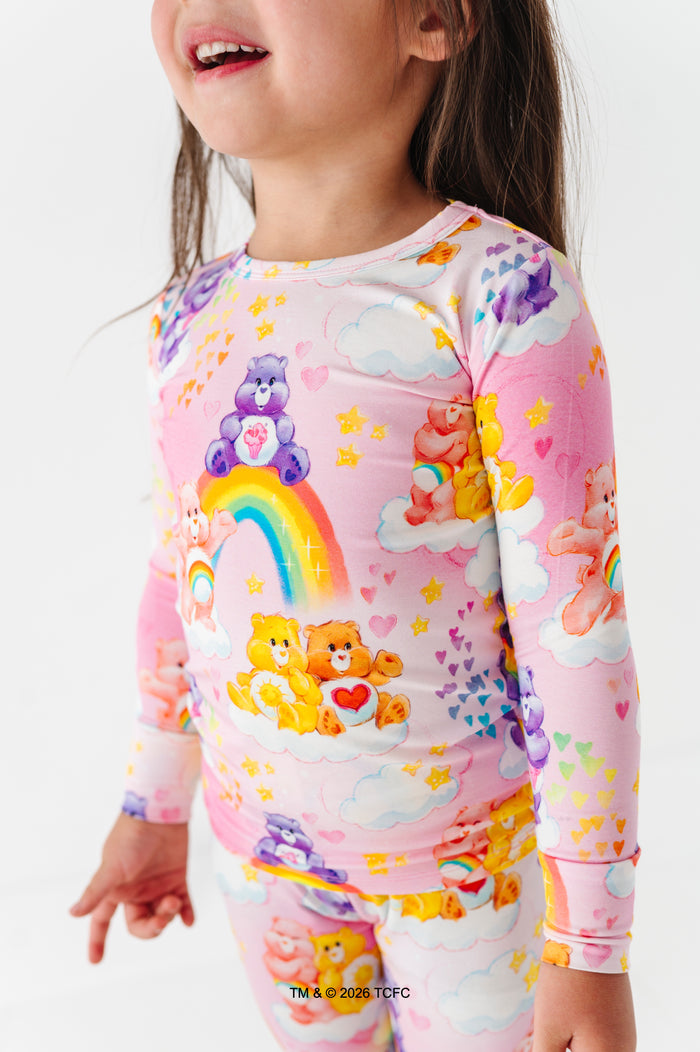 Child wearing a colorful Care Bears™ bamboo pajama set on a white background