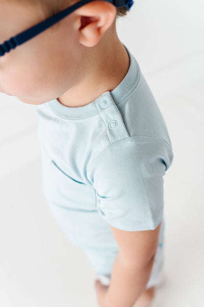 Close up detail shot of a boy's t-shirt shoulder snaps.