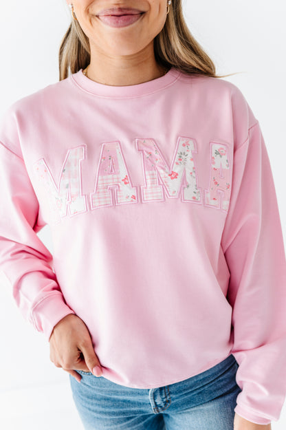 Mom wearing a pink bamboo/cotton sweatshirt with 'MAMA' printed on it against a white background