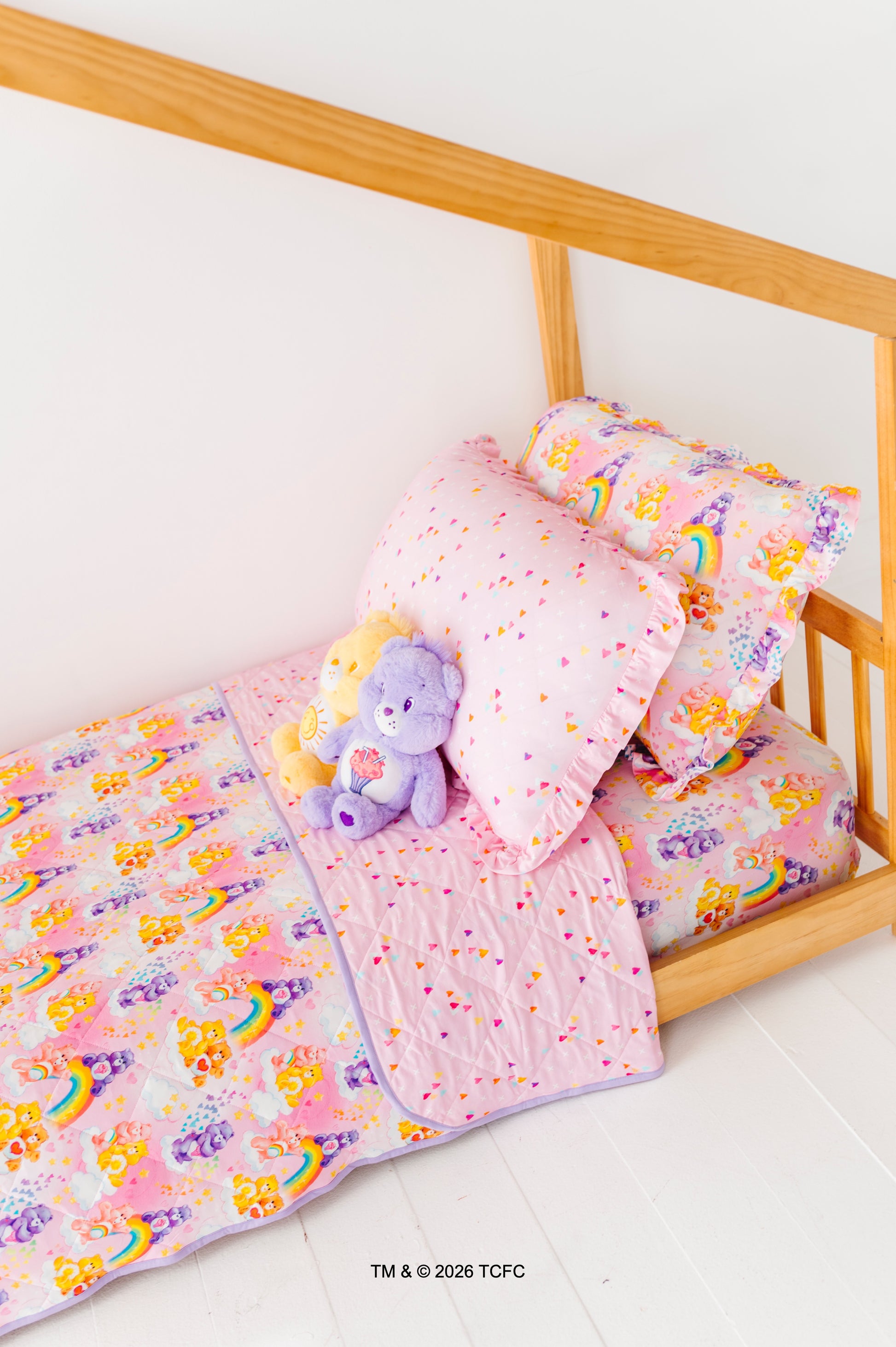 Children's twin-size bed featuring Care Bears™ bedding and plushes