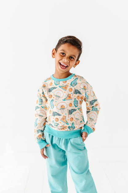 Child wearing a basketball bamboo daywear set with a white background