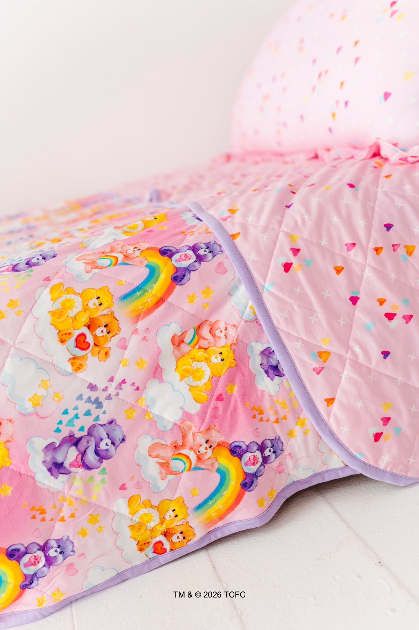 Colorful children's quilt featuring the Care Bears™ on a white background