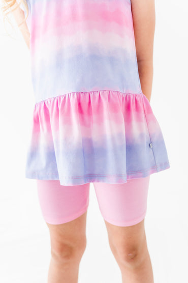 Pastel tie-dye bamboo-cotton peplum top with pink bamboo biker shorts on a white background