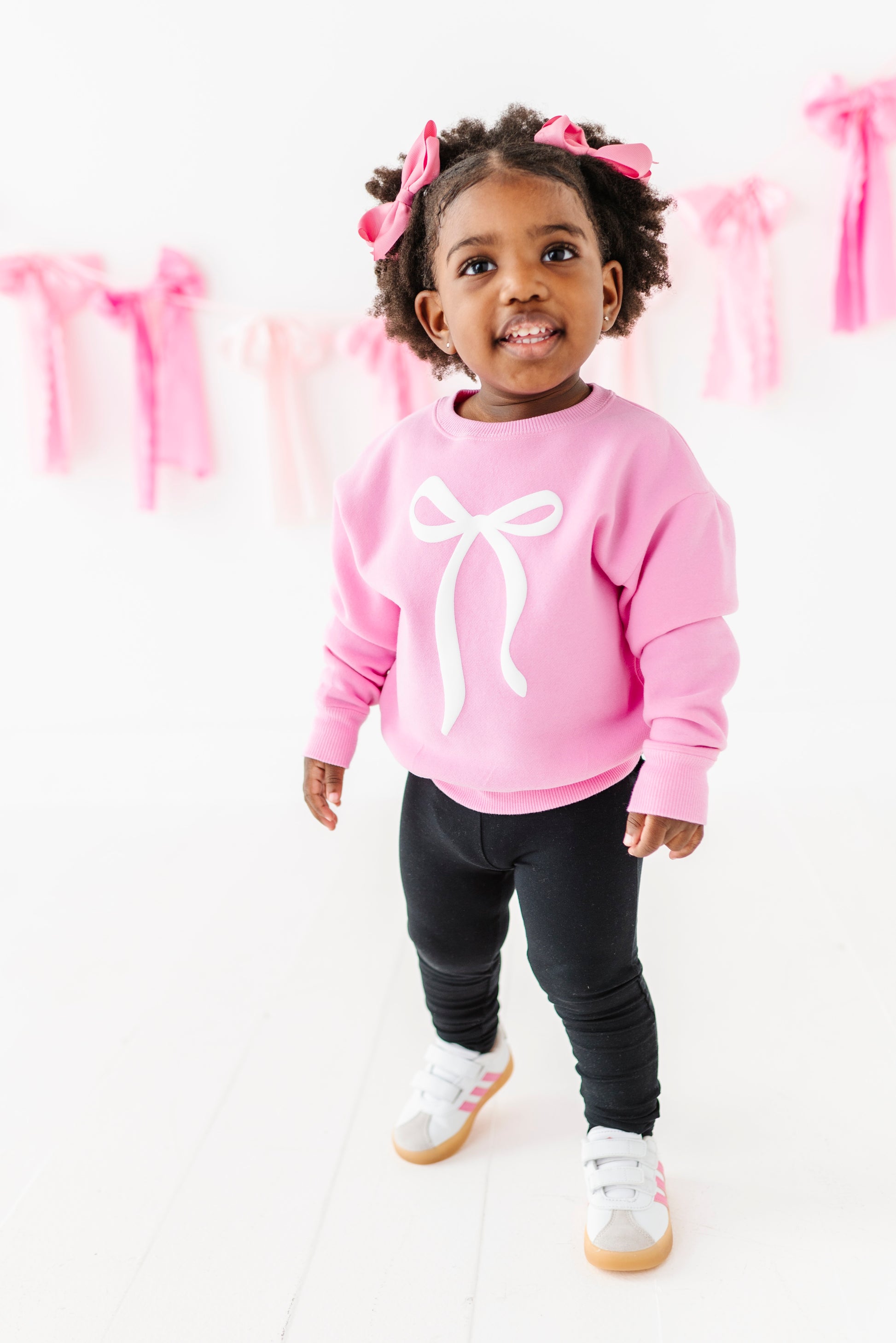 Child modeling slim-fit black leggings with elastic waistband