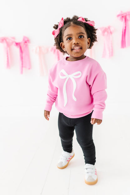 Child modeling slim-fit black leggings with elastic waistband