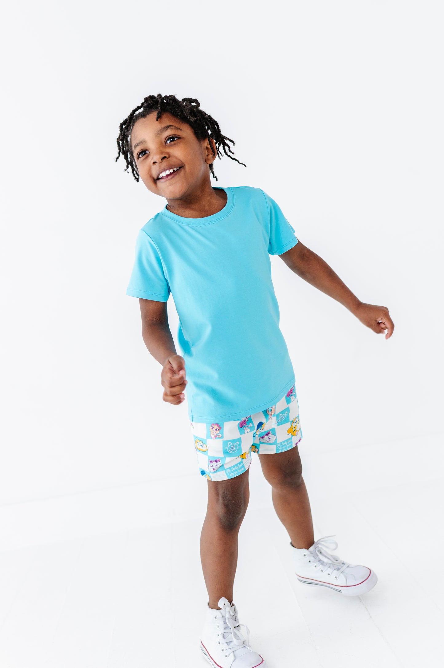 Child wearing a light blue bamboo blend t-shirt and 44 Cats licensed shorts on a white background
