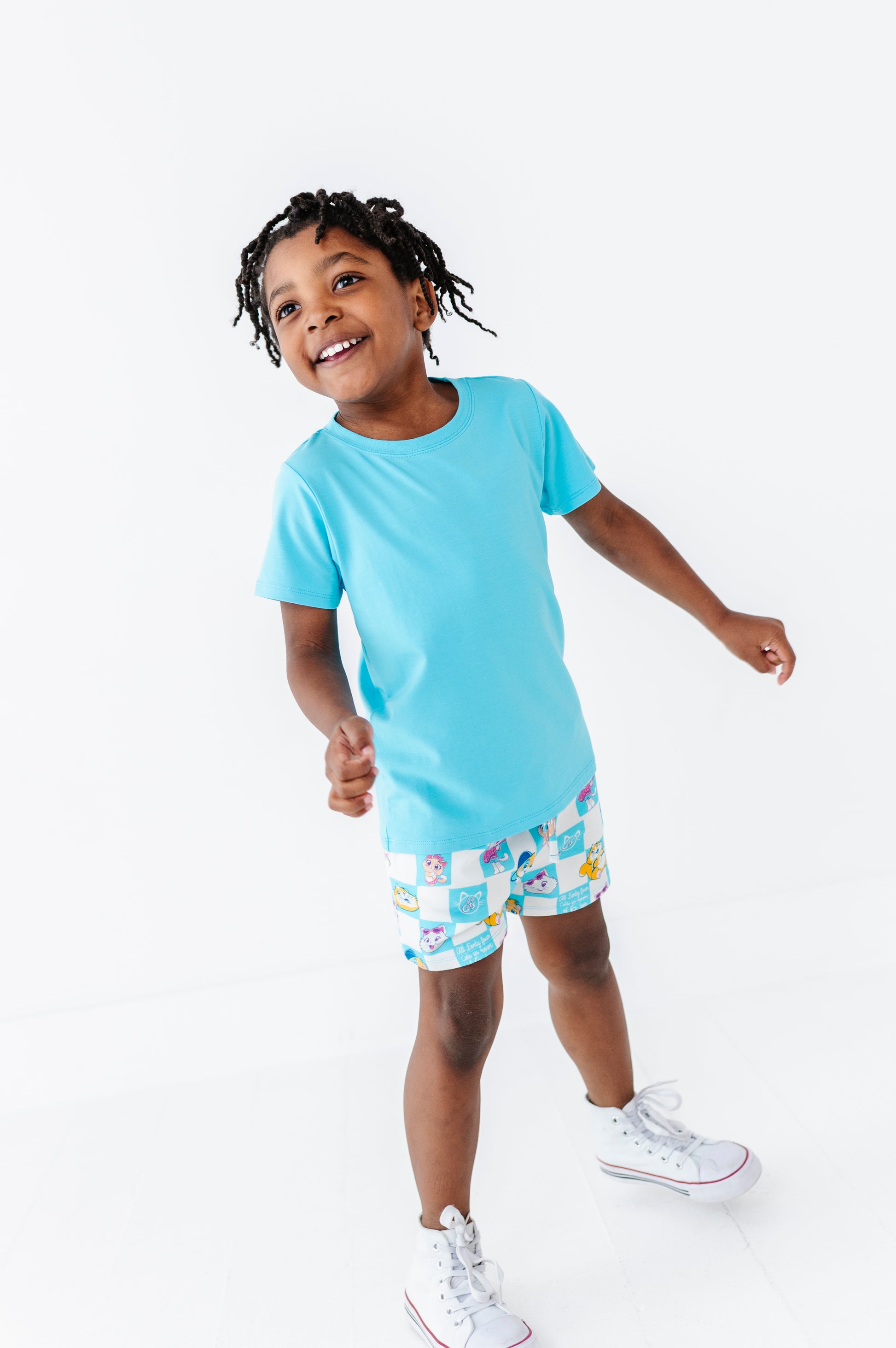 Child wearing a light blue bamboo blend t-shirt and 44 Cats licensed shorts on a white background