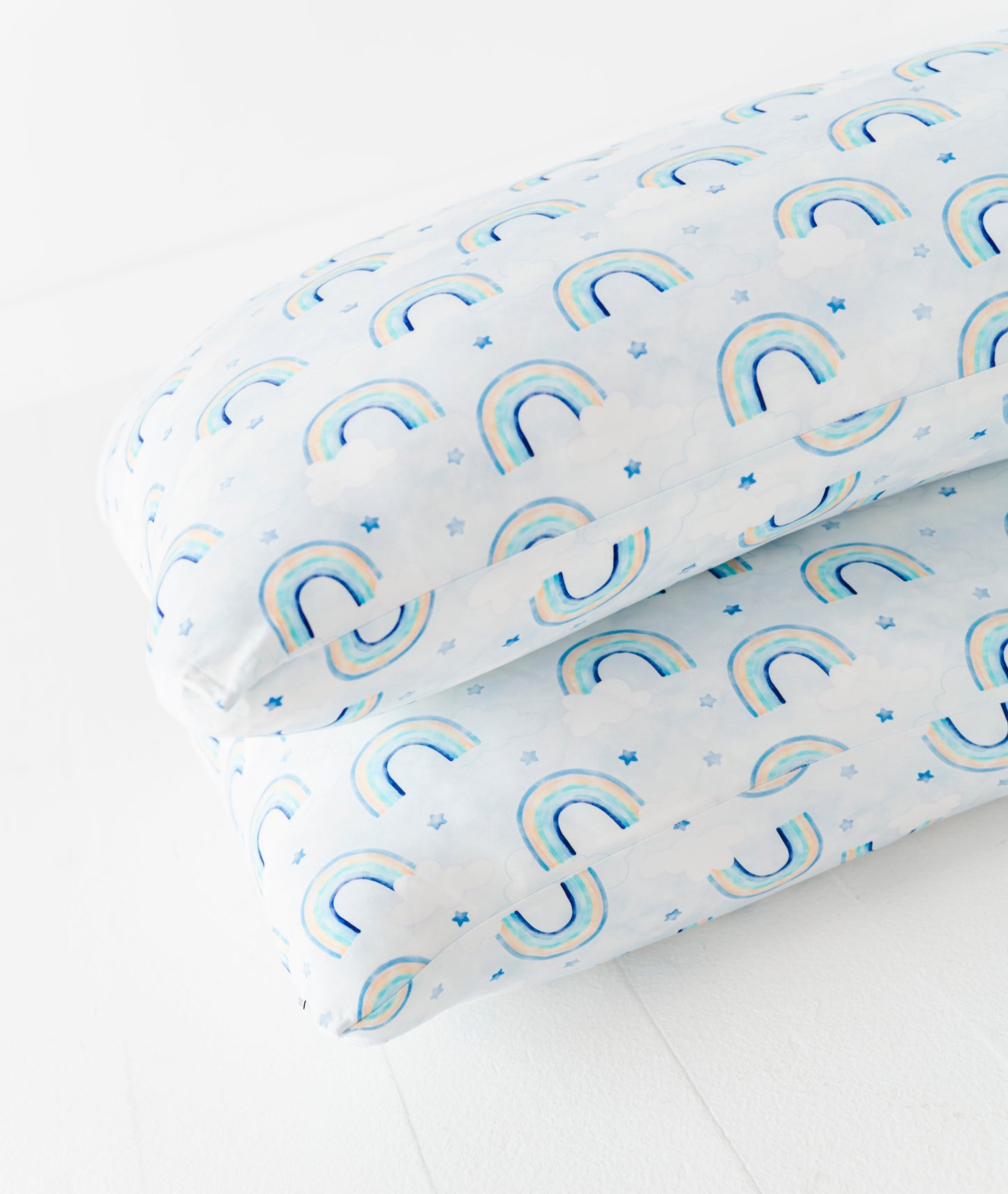Two bamboo pillow cases with a watercolor rainbow pattern on a white background